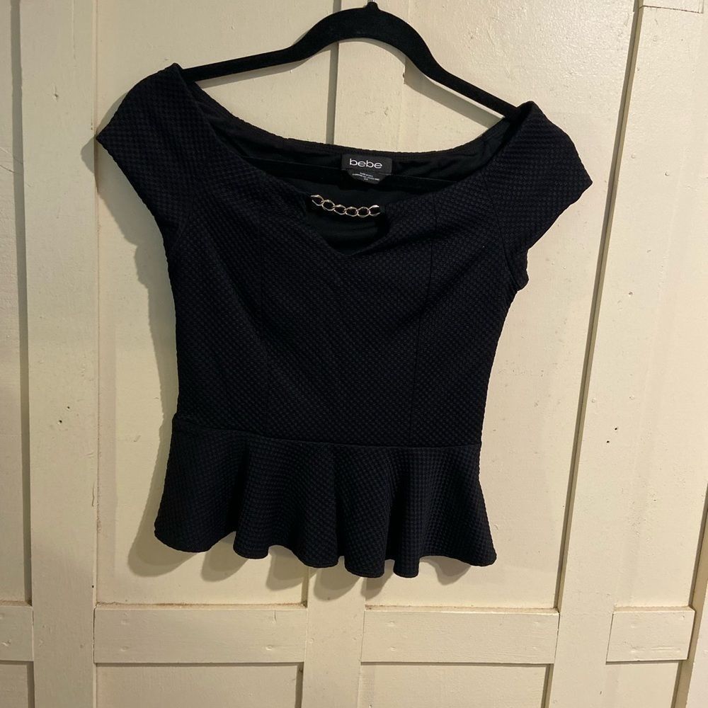 Bebe black peplum top with gold chain on front and side zipper size small